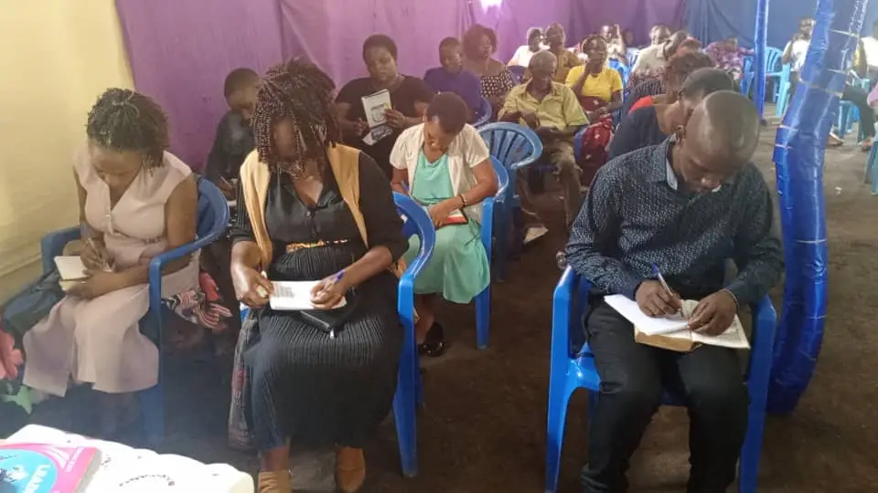 Congregation reading the bible during preaching session 2