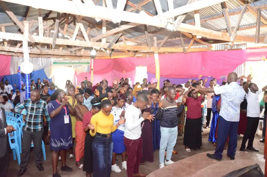 Pastor Benard praying for the new converts (25) who received Jesus Christ as personal Lord and Saviour