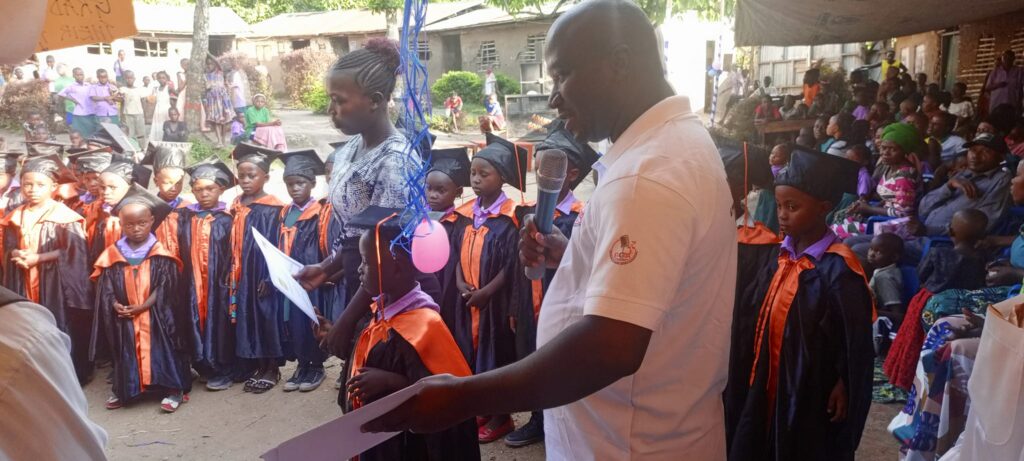 Pr. Benard handing the certificates to graduates